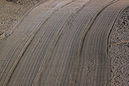 Cleaned by a tractor and people trampled sand on the Mediterranean beach in the morning. Antibes, Azure shore, France. Great space for writingの写真素材