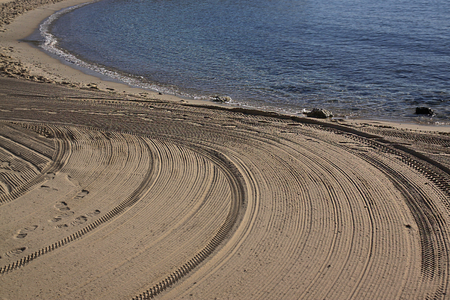 Cleaned by a tractor sand on the Mediterranean beach in the morning. Antibes, Cote d'Azur, France. Large space for writingの写真素材