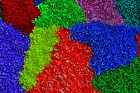 A background of many patches of multi-colored papier macheの写真素材