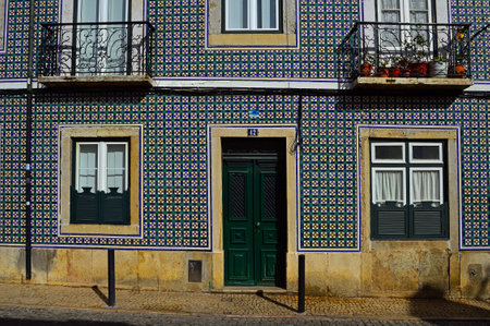 The old facade of the building is covered with azulejo ceramic tile. Cordoeiros Street 42, Lisbon, Portugal. November 02, 2018 Editorial photographyのeditorial素材