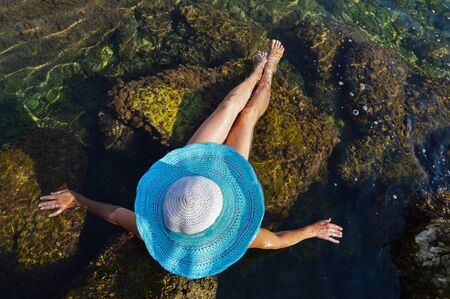 Young woman in blue and white beach hatの写真素材