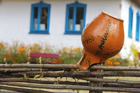 Ceramic jug on dries on the fence. Selective focusの写真素材