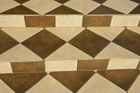 Concrete stairs are decorated with square, rectangular and triangular ceramic tiles