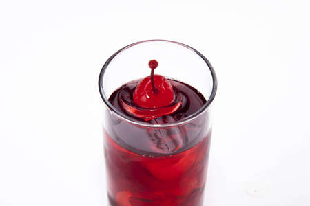 red coctail with cherry isolated on whiteの写真素材