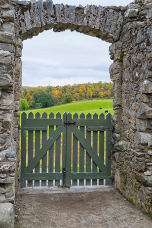 Looking through a stone archway to a countryside view