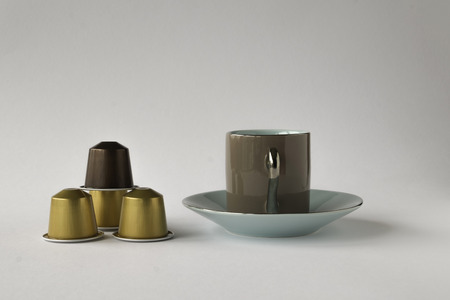 Espresso cup and saucer with coffee pods on white backgroundのeditorial素材
