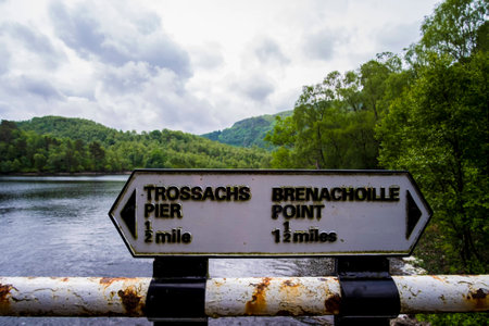 Signpost on railings by the side of Loch Katrine in the Trossachs Scotlandの写真素材