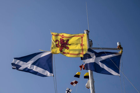 Royal Standard of Scotland with its red rampant lion on yellow background between two Scottish...