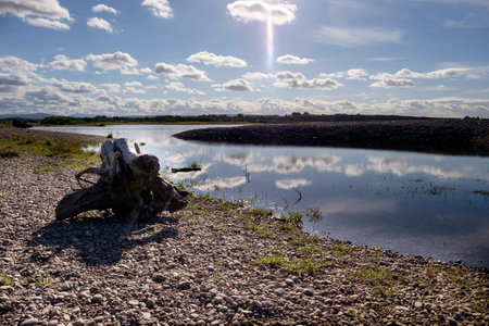 Beautiful Scottish landscape scene as sun shines through the clouds at the mouth of the River Spey...