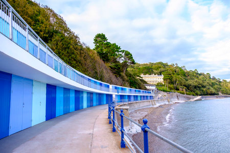 Beautiful row of colorful blue beach huts by the sea at Meadfoot Bay in the English Riviera town of Torquay, Devon, Englandの写真素材