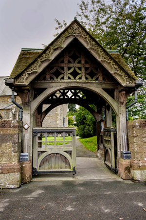 Beautiful elaborate carved stone and wood lychgate, entrance to English village Churchの写真素材