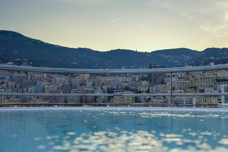 Looking over the hot tub on deck of a luxury cruise ship to exclusive Monte Carlo Monaco at sunsetのeditorial素材