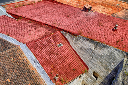 Looking down on colorful abstract pattern of terracotta roof tiles of buildings in Porto Mahon Menorca Spainの写真素材