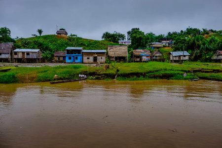 Remote village with typical wooden shack housing on the banks of the Amazon in Peruvian rainforest,の写真素材