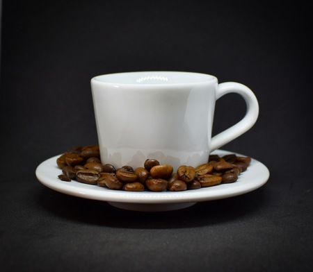 Coffee cup and beans with black background.の写真素材