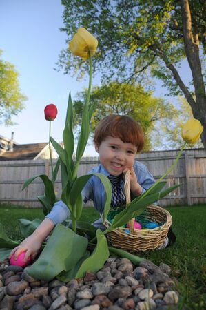 Little boy finds an egg during an Easter egg hunt