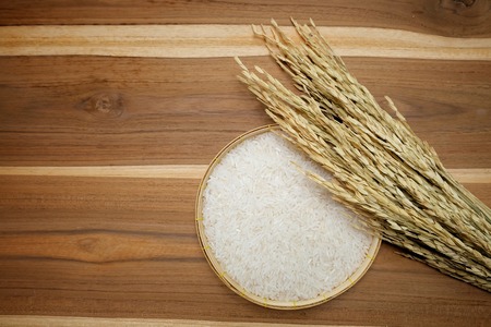 White rice in bowl on wooden background. Top view with copy space.の写真素材