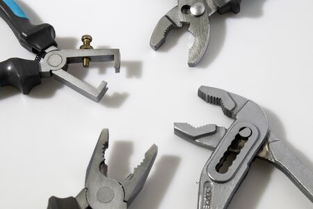 Blue flat-nose pliers in a white background compositionの写真素材