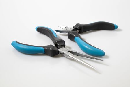 Blue flat-nose pliers in a white background compositionの写真素材