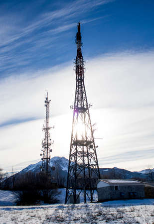 Telecommunication tower in a blue sky and cloudsの写真素材