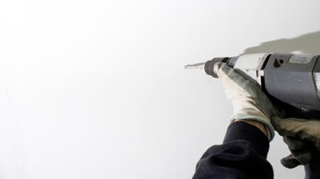 Rotary hammer in use composition in a white backgorundの写真素材