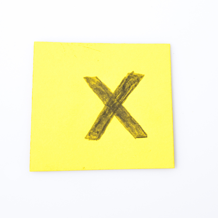 X alphabet letter handwrite on a yellow paper compositionの写真素材
