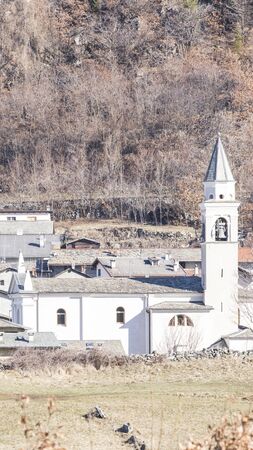 Church with bell tower and houses and plants compositionの写真素材
