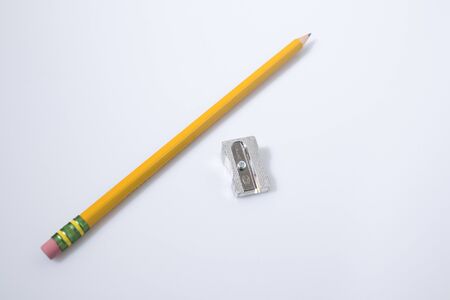 Chancellery, pencil and a sharpener in a white background compositionの写真素材