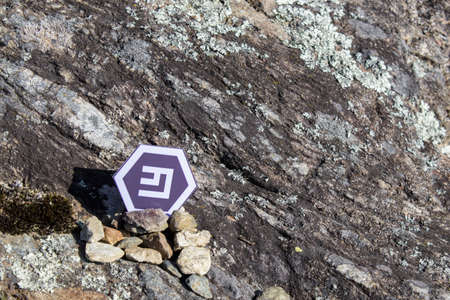 Cryptocurrency mining emercoin in a rock background composition