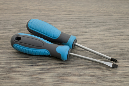 Tools, set blue screwdrivers on a wooden table background.の写真素材