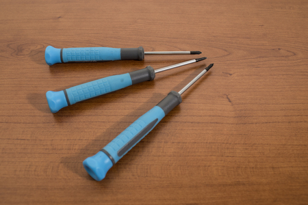 Tools, blue screwdrivers on a walnut table backgroundの写真素材