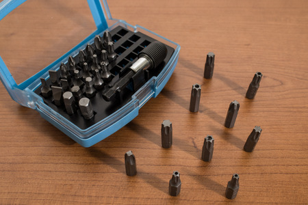 Tools, drill bits accessories on a wooden table backgroundの写真素材
