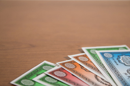 Colored fake banknotes on a wood table compositionの写真素材