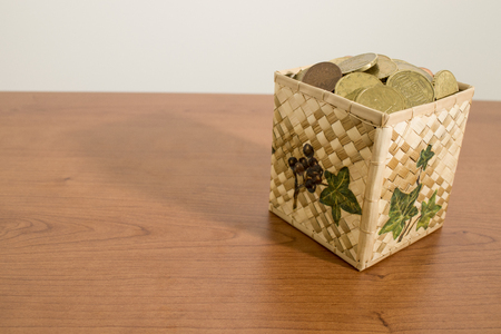 Box full of euro coins on a wood table compositionの写真素材