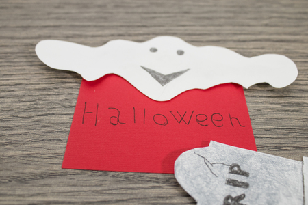 Halloween composition, halloween handwritten on a red paper with ghosts compositionの写真素材