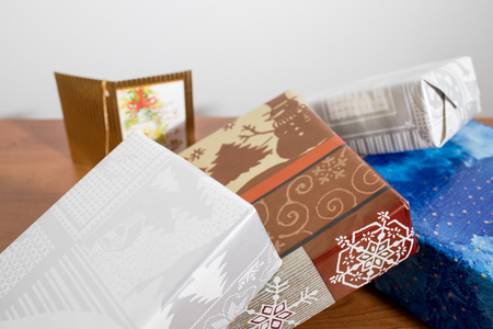 Many colorful christmas gifts on a wood table compositionの写真素材