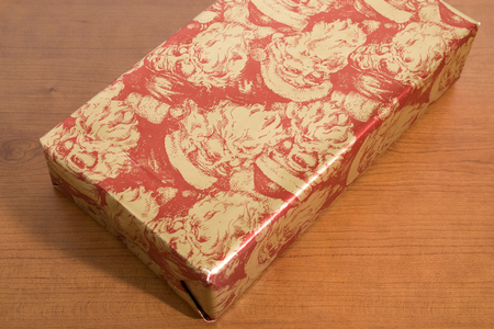 Red christmas gift on a wood table compositionの写真素材