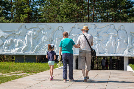 Russia, Luga, Leningrad oblast - 11 July 2020: photo shows people walking towards the monument, which depicts different people and soldiers. This is Monument "Artillery-glory!"のeditorial素材