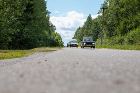 Russia, Mshinskaya - 11 July 2020: countryside, cars drive on a country road.のeditorial素材