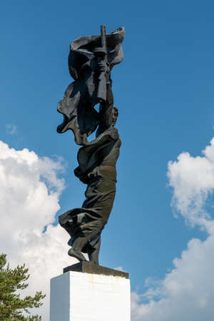 Russia, Luga, Leningrad oblast - 11 July 2020: photo shows a warrior with a machine gun in his hand. This is Monument "Artillery-glory!"のeditorial素材