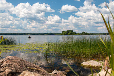 blue sky, lake and green grassの写真素材