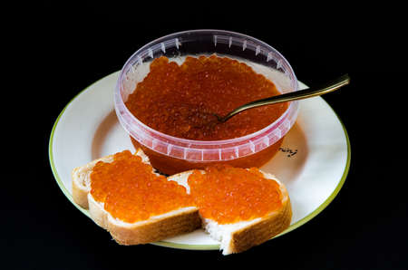 red caviar on sandwiches and in a jarの写真素材