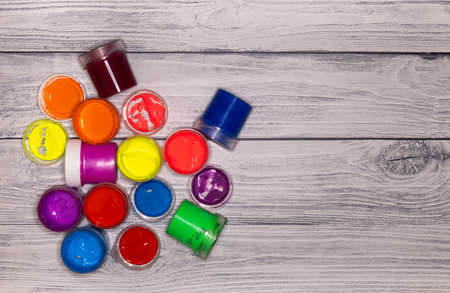 jars of paint on a wooden texture backgroundの写真素材