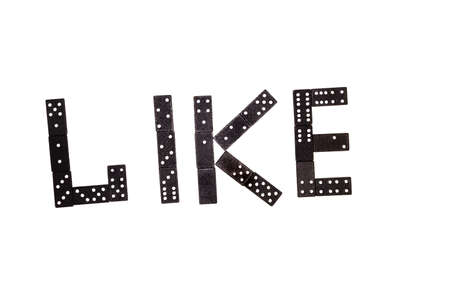 Word "like" made by black domino pieces isolated on white backgroundの写真素材