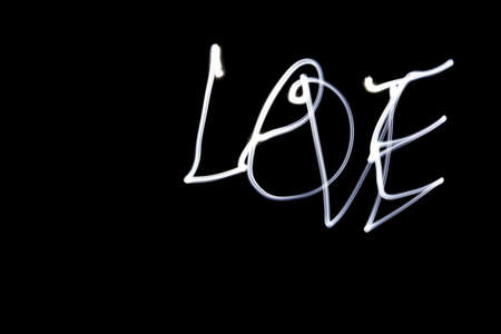 Glowing word LOVE in the darkness Freezelightの写真素材