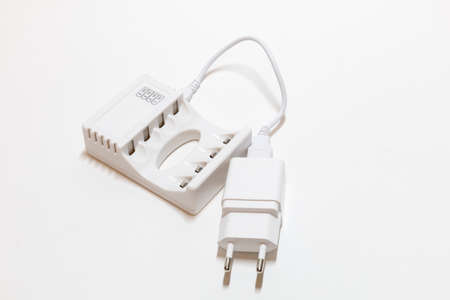 white charger for batteries on a white backgroundの写真素材