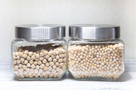 glass jar with peas and glass jar with chickpeasの写真素材