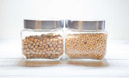 glass jar with peas and glass jar with chickpeasの写真素材