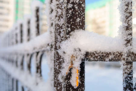 the keys are hanging on a frozen fence in the snowの写真素材
