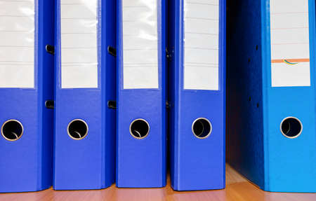 blue folders for papers on a shelf close-upの写真素材